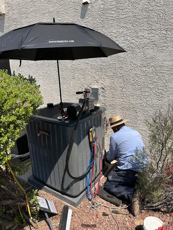 HVAC technician performing outdoor AC maintenance in Fort Stockton